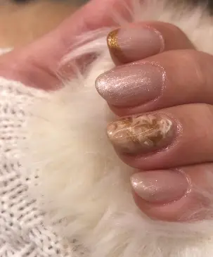 Unhas claras com nail art em dourado